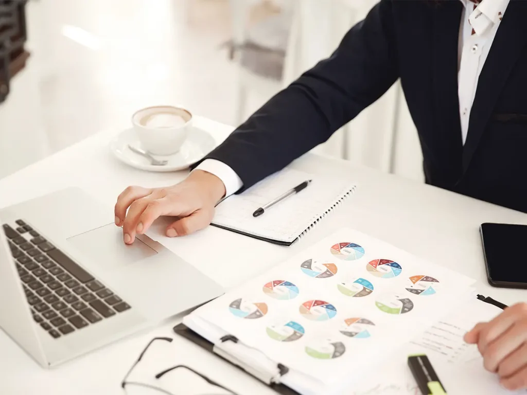 Manager reviewing financial charts on a laptop for Owners Corporation Management Melbourne.